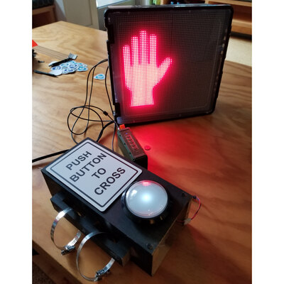 The crosswalk box and small button box on a table.